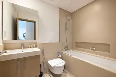 a bathroom with a toilet and a tub and a sink at Emaar 52 42! Iconic Sea-View! Dubai Marina in Dubai