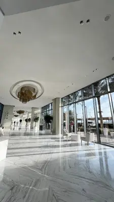 a large lobby with white chairs and windows at Emaar 52 42! Iconic Sea-View! Dubai Marina in Dubai