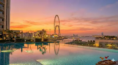 a large swimming pool with a ferris wheel in the background at Emaar 52 42! Iconic Sea-View! Dubai Marina in Dubai