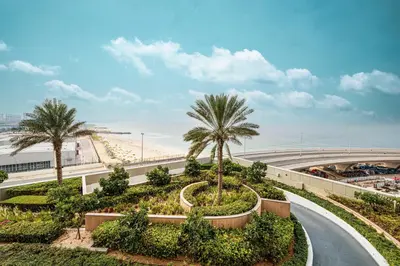 a road with palm trees and the beach at Emaar 52 42! Iconic Sea-View! Dubai Marina in Dubai