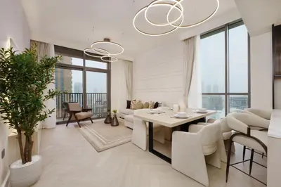 a living room with a table and chairs at Calm & Stylish 1Bedroom in Hadley Heights JVC in Dubai