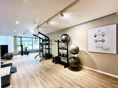 a room with a gym with exercise equipment on the wall at Grand Bleu 1, Emaar Beachfront - Mint Stay in Dubai
