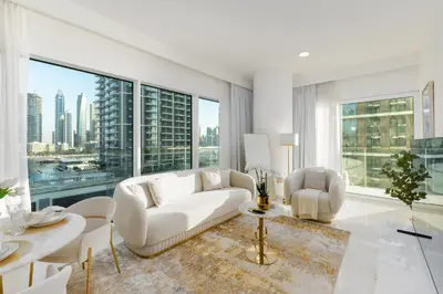 a living room with white furniture and large windows at Grand Bleu, Emaar Beachfront - The Mint Stay in Dubai