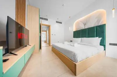 a bedroom with a large bed and a flat screen tv at Luxury Spacious 5 bed Villa Pool and Garden in Dubai