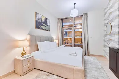 a bedroom with a white bed and a window at 2BHK Canal View Stay-Business Bay in Dubai