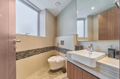 a bathroom with a sink and a toilet at Stunning Burj Khalifa View 3BR Imperial Avenue in Dubai