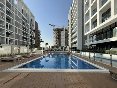 a swimming pool in the middle of a building at Fresh & Modern Studio in Meydan - Azizi Riviera 67 in Dubai