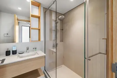 a bathroom with a shower and a sink at Elegant 2BR Close to Park in Park Horizon in Dubai