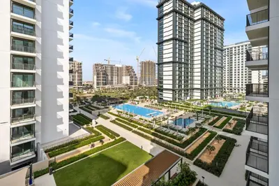 an aerial view of a courtyard with two tall buildings at Elegant 2BR Close to Park in Park Horizon in Dubai