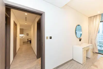 a hallway with a door leading into a room with a mirror at Escape24 Brand New 2BR with Canal Views near Burj Khalifa in Dubai