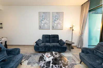 a living room with two couches and a table at Escape24 Brand New 2BR with Canal Views near Burj Khalifa in Dubai