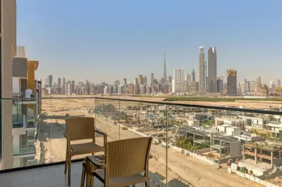 a balcony with two chairs and a city skyline at Stylish 1BR in Great Community in Dubai