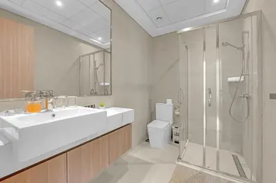 a bathroom with a sink and a shower and a toilet at Stylish 1BR in Great Community in Dubai