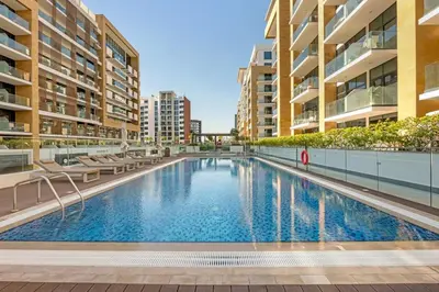 a swimming pool in the middle of a building at Stylish 1BR in Great Community in Dubai