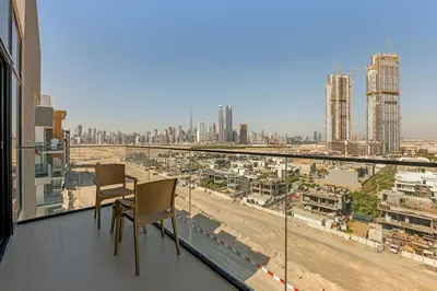 a balcony with chairs and a view of a city at Stylish 1BR in Great Community in Dubai