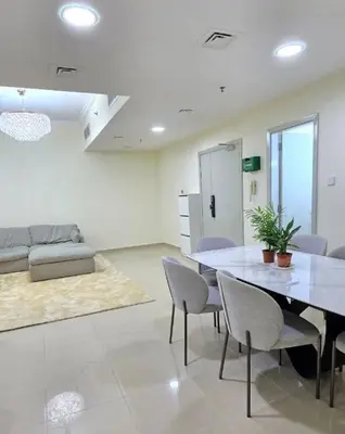 a living room with a dining room table and chairs at Large 2 BHK Apartment Next to DMCC Metro Station in Dubai