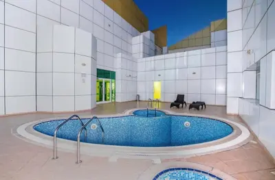 a large swimming pool in a building at Large 2 BHK Apartment Next to DMCC Metro Station in Dubai