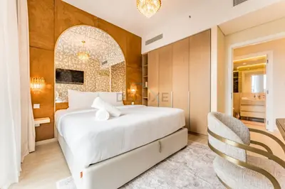 a bedroom with a white bed and a dining room at Community View, Near Dubai Creek Harbour Marina Walk - Summer at Creek Beach Building 2 by Deluxe Holiday Homes in Dubai