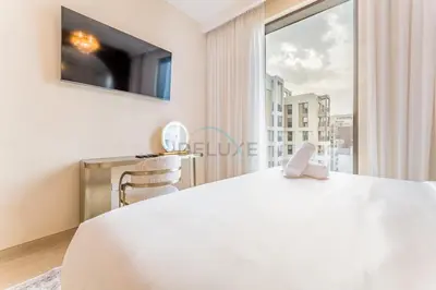 a bedroom with a large white bed and a window at Community View, Near Dubai Creek Harbour Marina Walk - Summer at Creek Beach Building 2 by Deluxe Holiday Homes in Dubai