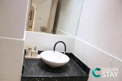 a bathroom with a sink and a mirror at Cloud 9 - Steps to the Beach Elegant 2BR in JBR in Dubai