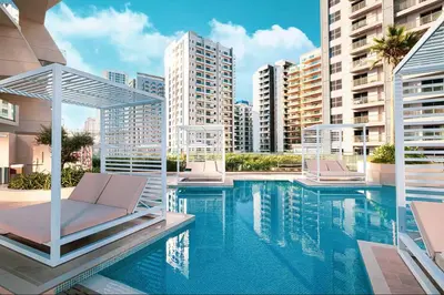 a swimming pool with two lounge chairs and buildings at Vogue JVC Binghatti Phantom near Circle Mall, One Bedroom Apartment with Large Balcony and City View, Access to all Amenities in Dubai