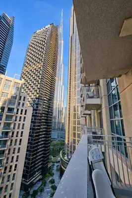 a view of a city from the balcony of a building at 1BR with Burj Khalifa Modern Comfort in Dubai