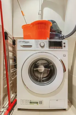 a washing machine with a bucket on top of it at Keylid Stunning3BR and Maid connected to Dubai Mall in Dubai