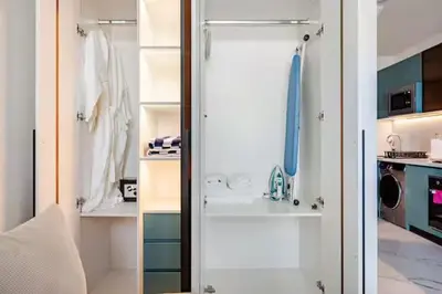 a walk in closet with a glass door at Luxury Dubai Studio with Private Pool & Desert Views in Dubai
