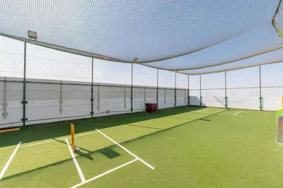 a tennis court with a net on top of it at Luxury Dubai Studio with Private Pool & Desert Views in Dubai