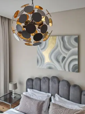 a chandelier hanging over a bed in a room at Amazing 1BR Address Beach Resort With Private Beach in Dubai