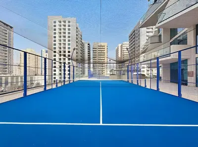 a tennis court in the middle of a city at New 1BR with Private Pool Near Circle Mall in Dubai