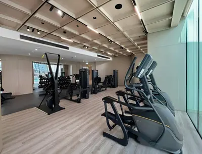 a gym with treadmills and ellipticals in a room at Stylish 1BR with Private Pool Near Circle Mall in Dubai