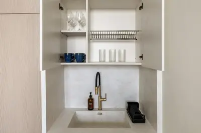 a sink in a kitchen with a sink at Stylish 1BR with Private Pool Near Circle Mall in Dubai