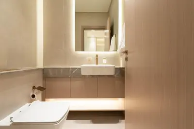 a bathroom with a sink and a toilet and a mirror at Royale Family Apartment 281 with Plunge Pool in Dubai