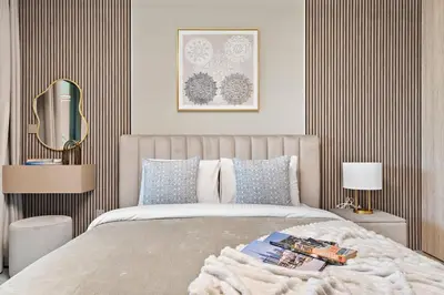 a bedroom with a bed with a blanket on it at The Smart Concierge - Peninsula One in Dubai