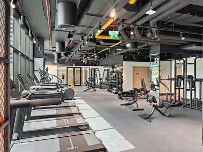 a gym with a bunch of treadmills and machines at The Smart Concierge - Peninsula One in Dubai