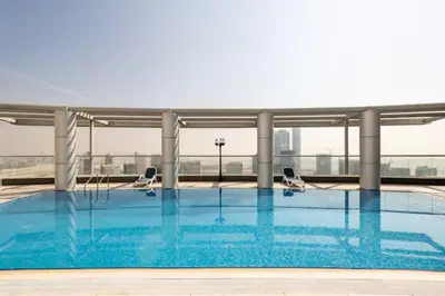 a swimming pool on the roof of a building at Maison Privee - Comfortable Downtown Apartment with City Skyline Vws in Dubai