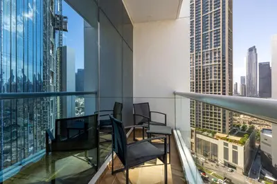 a balcony with chairs and a view of a city at Maison Privee - Comfortable Downtown Apartment with City Skyline Vws in Dubai