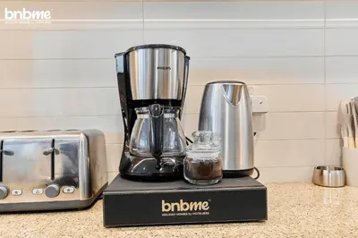 a blender sitting on a counter next to a toaster at bnbmehomes - Burj Vista Tower 1 in Dubai