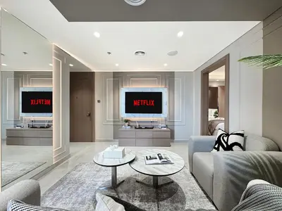 a living room with a couch and a tv at Modern 1BR Escape with Balcony View in Dubai