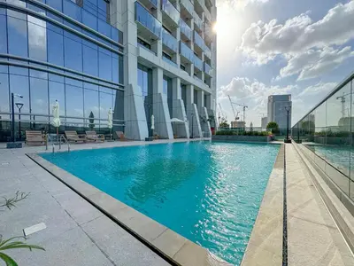 a swimming pool in the middle of a building at Modern 1BR Escape with Balcony View in Dubai