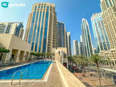 a swimming pool in a city with tall buildings at HiGuests - Family Friendly 1BR Near Burj Khalifa in Dubai