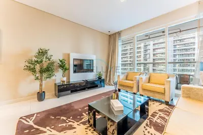 a living room with a couch and a tv at Prime Waterfront Living, Just Moments from Marine Transport, Bus Stops, and Dubai Water Canal, Waters Edge, Business Bay by Deluxe Holiday Homes in Dubai