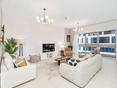 a living room with two couches and a tv at Kensington-2BR Huge & Central at Executive Tower in Dubai