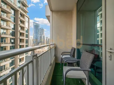 a balcony with chairs and a view of a city at Zapbed Stylish Studio Boulevard Central 2 Down Town Dubai in Dubai