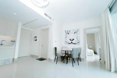 a dining room with a table and a picture of a tiger at Luxury 1BR Apartment near Burj Khalifa & Dubai Mall in Dubai