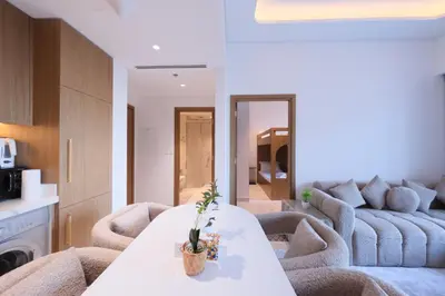 a living room with a couch and a table at Modern 2BR Retreat Azizi Riviera 61 Square in Dubai