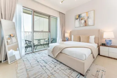 a bedroom with a large bed and a balcony at Stylish 2BHK with Burj Khalifa Views in Downtown in Dubai