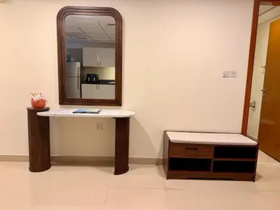 a bathroom with a mirror and a table and a stool at Panoramic Luxury 1BR at Park Towers, DIFC, Dubai, Stunning City View in Dubai