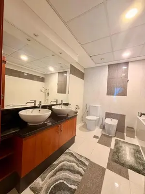 a bathroom with two sinks and two toilets at Panoramic Luxury 1BR at Park Towers, DIFC, Dubai, Stunning City View in Dubai
